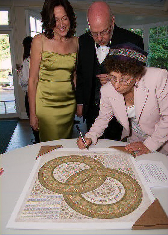 Suri signing a married couple's ketuba